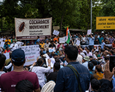 Jantar Mantar Delhi protests July 2026 with a large crowd gathered near the iconic Jantar Mantar sign, protesters holding placards and Indian flags during the latest Cockroach Movement demonstration in New Delhi.