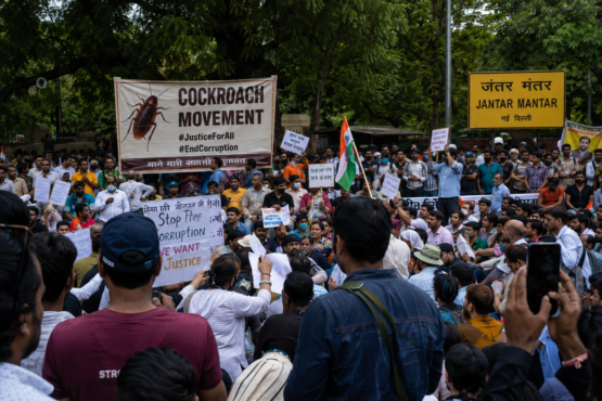 Jantar Mantar Delhi protests July 2026 with a large crowd gathered near the iconic Jantar Mantar sign, protesters holding placards and Indian flags during the latest Cockroach Movement demonstration in New Delhi.