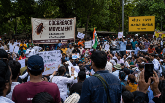 Jantar Mantar Delhi protests July 2026 with a large crowd gathered near the iconic Jantar Mantar sign, protesters holding placards and Indian flags during the latest Cockroach Movement demonstration in New Delhi.