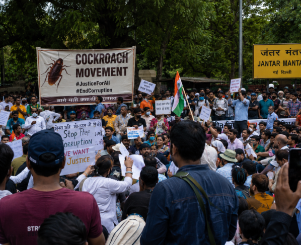 Jantar Mantar Delhi protests July 2026 with a large crowd gathered near the iconic Jantar Mantar sign, protesters holding placards and Indian flags during the latest Cockroach Movement demonstration in New Delhi.