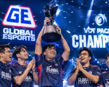 Global Esports players celebrate their VCT Pacific Championship victory as the team captain lifts the championship trophy on stage amid confetti